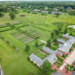 Areal across the street of gardens and little village